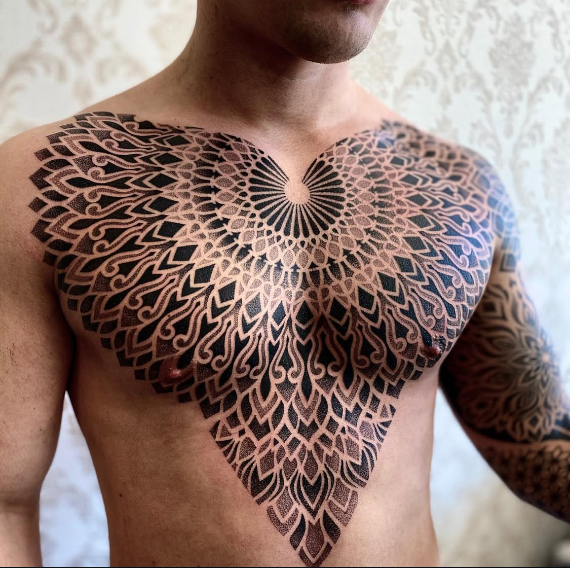 Geometric ornamental chest tattoo by Dezso Jakab