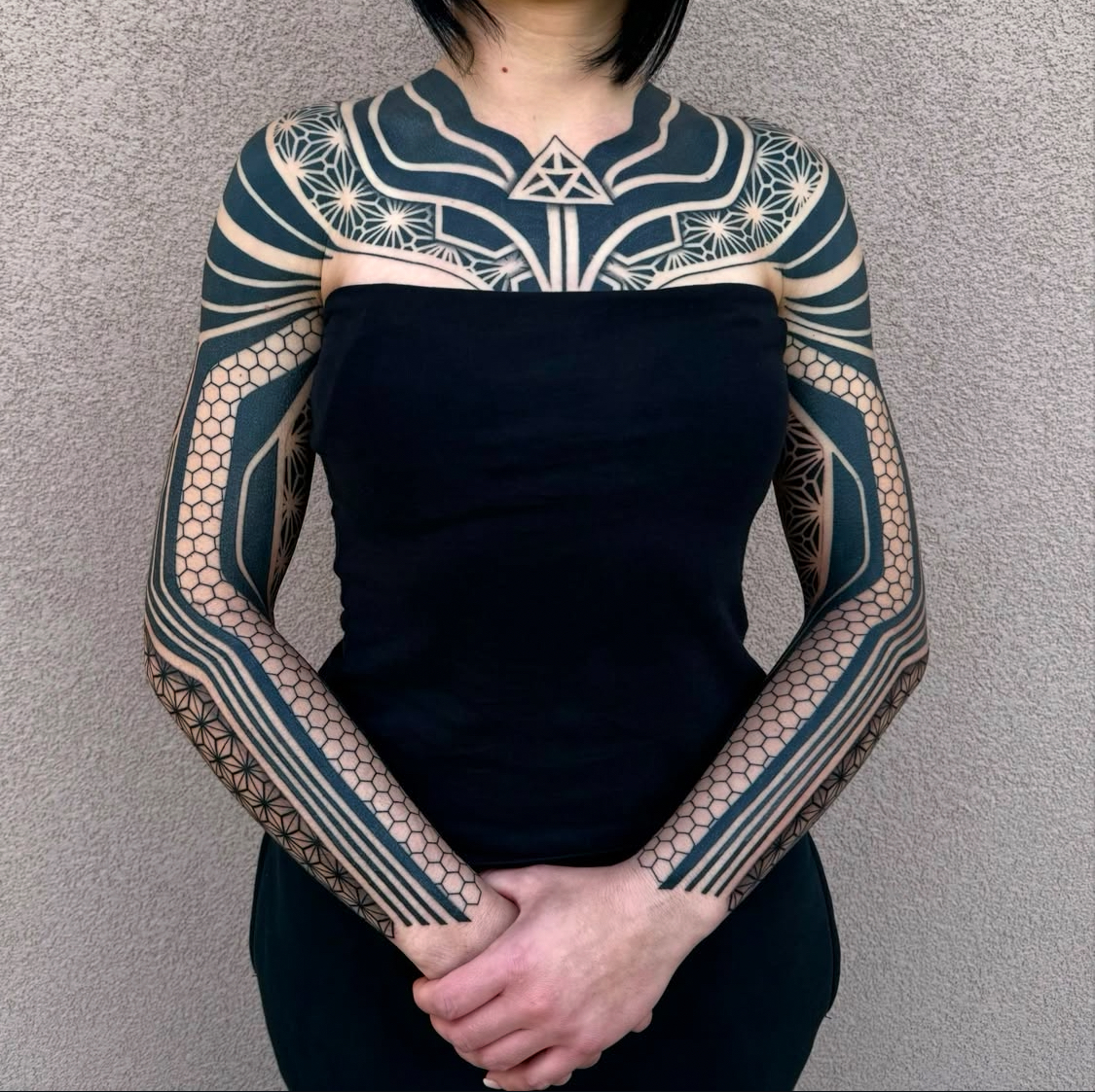 Geometric sleeve and chest tattoo by Dezso Jakab